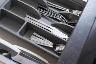 a drawer filled with silver utensils in a drawer at Apartment for two - Piłsudskiego 1 Street in Kraków