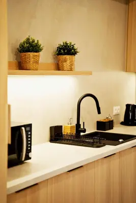 a kitchen counter with a sink and a microwave at Magic Apartments - Siena in Zator