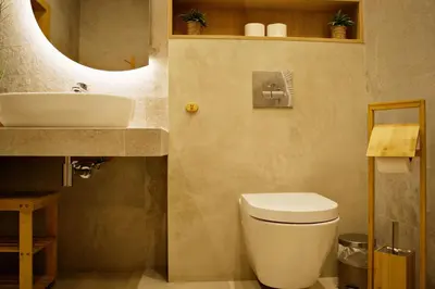 a bathroom with a white toilet and a sink at Magic Apartments - Siena in Zator