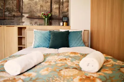 a bed with two pillows on top of it at Magic Apartments - Siena in Zator