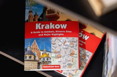 a book on krakow on a shelf at Kiełkowskiego Modern & Comfy Apartment with Balcony Cracow by Noclegi Renters in Kraków