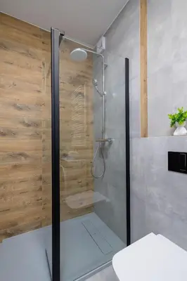 a shower with a glass door in a bathroom at Kiełkowskiego Modern & Comfy Apartment with Balcony Cracow by Noclegi Renters in Kraków