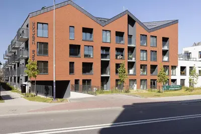 a large brick building on the side of a street at Kiełkowskiego Modern & Comfy Apartment with Balcony Cracow by Noclegi Renters in Kraków