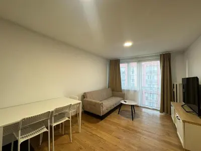 a living room with a table and a couch at Apartament Bałandy 26 in Oświęcim