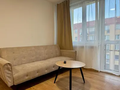 a living room with a couch and a table at Apartament Bałandy 26 in Oświęcim