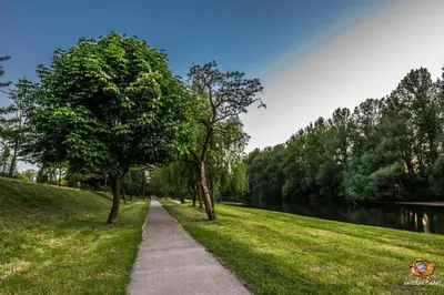 a path through a park next to a river at Apartament Bałandy 26 in Oświęcim