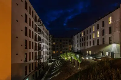 an alley between two tall buildings at night at Apartament Bałandy 26 in Oświęcim
