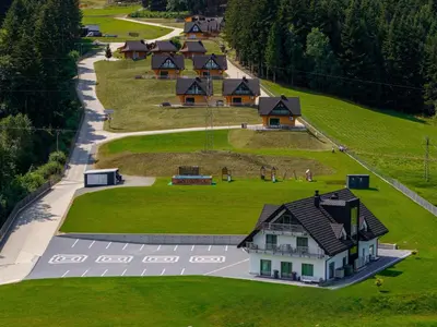 an overhead view of a house on a green field at Kompleks Gazdówka - Dom Jana in Ponice
