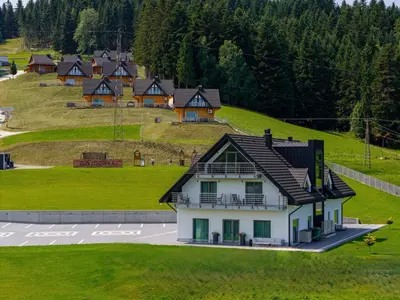 a house on top of a hill with houses at Kompleks Gazdówka - Dom Jana in Ponice