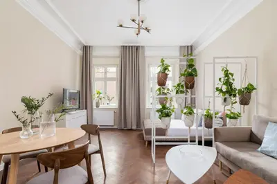 a living room filled with lots of plants at 3-Bedroom Apartment - Rejtana 10 in Kraków