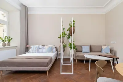 a living room with a bed and a couch at 3-Bedroom Apartment - Rejtana 10 in Kraków