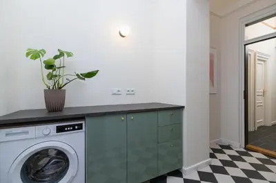 a laundry room with a washer and dryer at 3-Bedroom Apartment - Rejtana 10 in Kraków