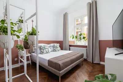 a bedroom with a bed with plants in it at 2-Bedroom Apartment - Rejtana 10 in Kraków