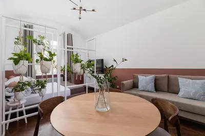a living room with a table and a couch at 2-Bedroom Apartment - Rejtana 10 in Kraków