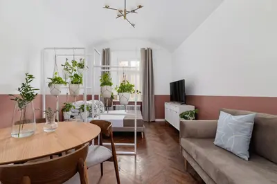 a living room with a couch and a table with plants at 2-Bedroom Apartment - Rejtana 10 in Kraków