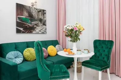 a living room with a green couch and a table at 1 - bedroom Apartment - Plac na Groblach 19 in Kraków