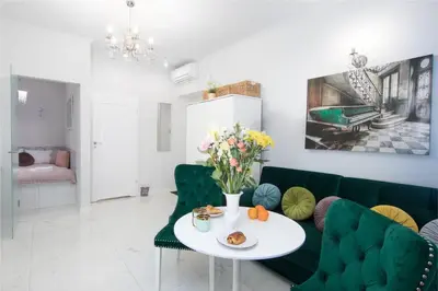 a living room with a green couch and a table at 1 - bedroom Apartment - Plac na Groblach 19 in Kraków