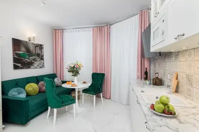 a living room with a green couch and a table at 1 - bedroom Apartment - Plac na Groblach 19 in Kraków