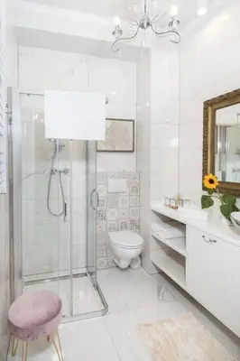 a white bathroom with a shower and a toilet at 1 - bedroom Apartment - Plac na Groblach 19 in Kraków