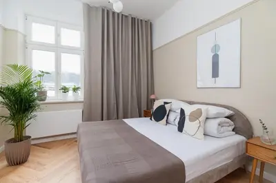a bedroom with a bed and a window at 2 - bedroom Apartment - Rejtana 10 in Kraków