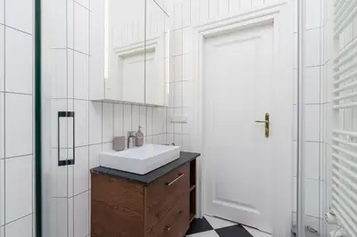 a bathroom with a sink and a mirror at 2 - bedroom Apartment - Rejtana 10 in Kraków