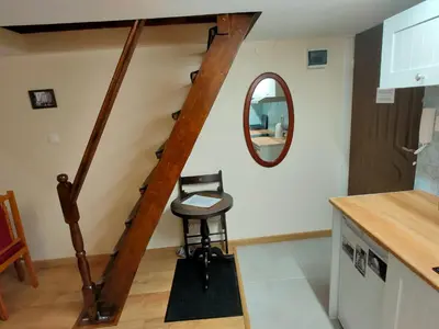 a stairway with a stool and a mirror at Krakow Old Town Apartment in Kraków