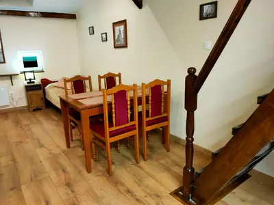 a dining room with a table and chairs and a bed at Krakow Old Town Apartment in Kraków