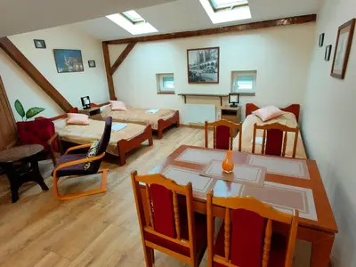a room with a table and chairs and a living room at Krakow Old Town Apartment in Kraków