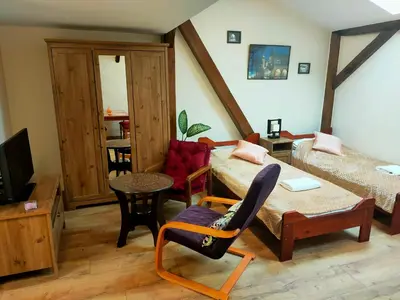 a living room with a couch and a chair at Krakow Old Town Apartment in Kraków