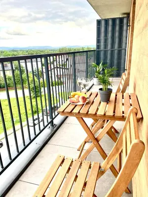 a wooden table and chairs on a balcony with a view at Sonja in Zator