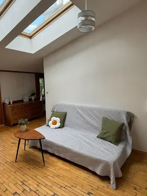 a living room with a couch and a table at Blue Moon Main Square Apartment in Kraków