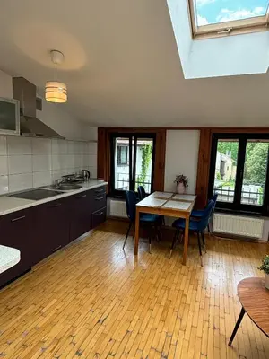 a kitchen with a table and chairs in a room at Blue Moon Main Square Apartment in Kraków