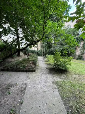 a walk way in a park with a tree at Blue Moon Main Square Apartment in Kraków