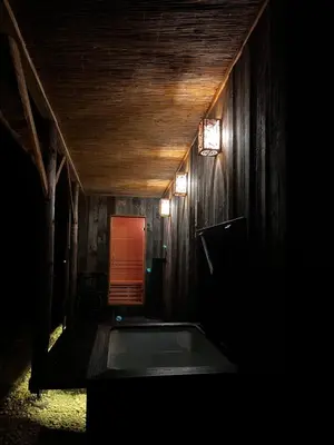 a dark room with a bath tub in a house at Riwiera Strzelecka in Strzelce Małe