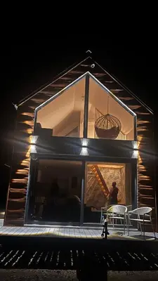 a man standing in front of a house with a table at Riwiera Strzelecka in Strzelce Małe
