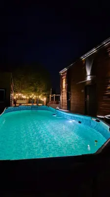 a large blue swimming pool at night at Riwiera Strzelecka in Strzelce Małe
