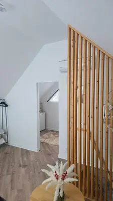 a room with a staircase and a table with a stuffed animal at Riwiera Strzelecka in Strzelce Małe