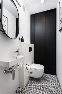 a bathroom with a toilet and a sink and a mirror at SOL Apartment in Kraków