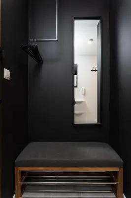 a bench in a bathroom with a mirror at SOL Apartment in Kraków