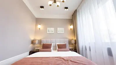 a bedroom with a bed and two chairs at Avanti Villa in Kraków