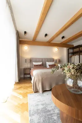 a bedroom with two beds and a table in a room at Avanti Villa in Kraków