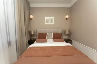 a bedroom with a large bed with brown pillows at Avanti Villa in Kraków