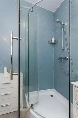 a bathroom with a shower with a glass door at Apartment with balcony - Rzeszowska 4 Street in Kraków
