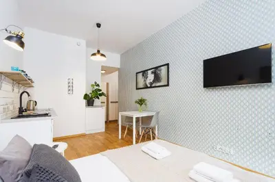 a living room with a tv on a wall at Apartment with balcony - Rzeszowska 4 Street in Kraków