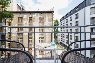 a balcony with a table and a book on it at Apartment with balcony - Rzeszowska 4 Street in Kraków