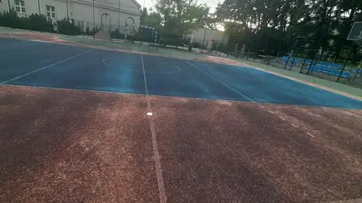 an empty basketball court with a basketball hoop at Apartamenty Kraków-Bielany in Kraków