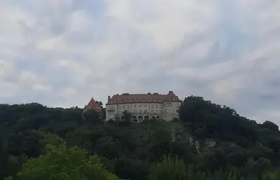 a castle on top of a hill with trees at Apartamenty Kraków-Bielany in Kraków