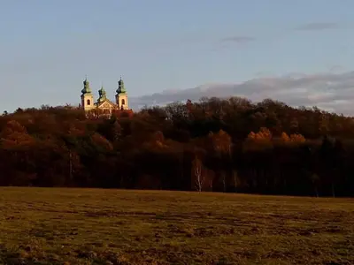 a castle on top of a hill in a field at Apartamenty Kraków-Bielany in Kraków