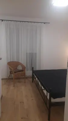 a living room with a table and a chair at Apartamenty Kraków-Bielany in Kraków