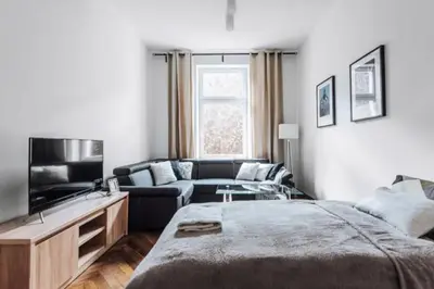 a living room with a large bed and a couch at Apartment with balcony - 21 Filipa Street in Kraków